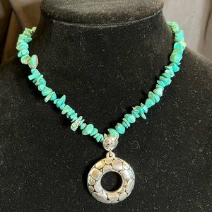 Necklace with turquoise colored beads and silver metal pendant, adjustable